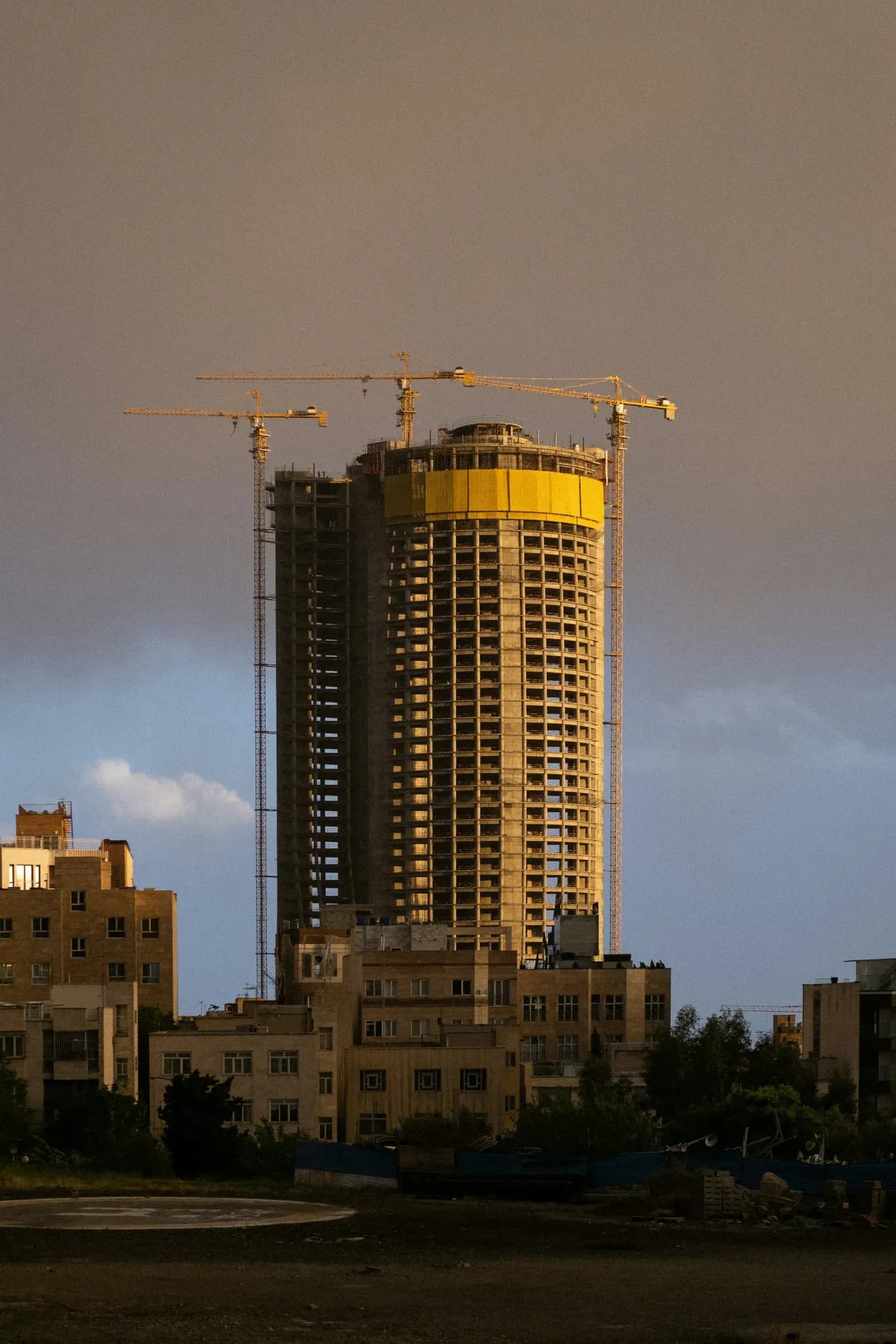 Concrete building under construction at sunset